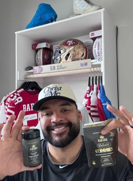NFL player Alex Barrett holding Black Lotus Shilajit tablets and gummies